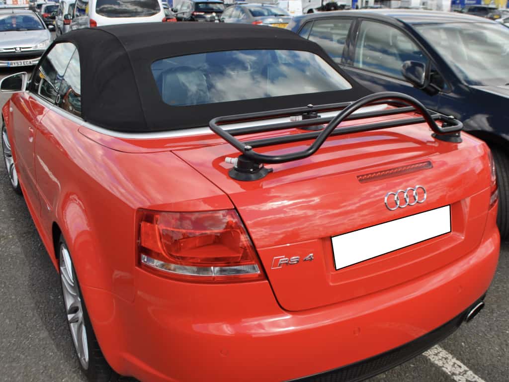 red audi a4 convertible with black luggage rack fitted in a car park