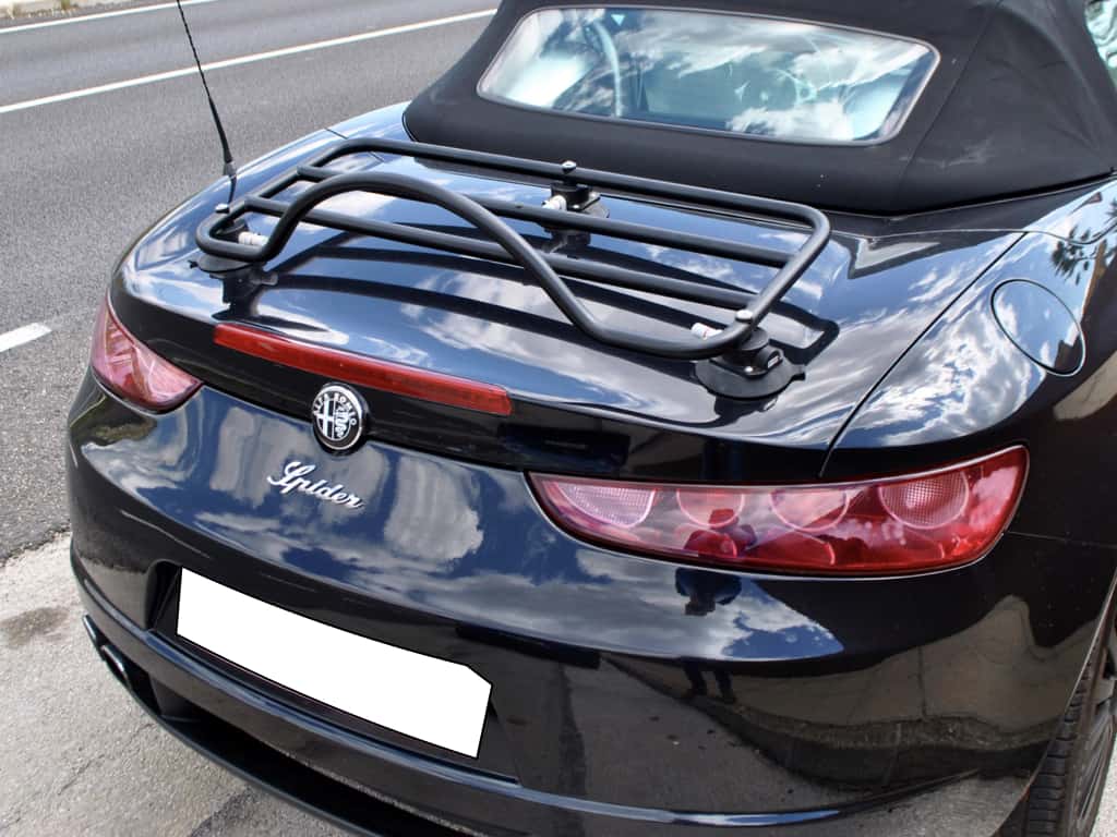 alfa romeo brera spider luggage rack in black fitted to a black 939 spider with the hood up next to a road