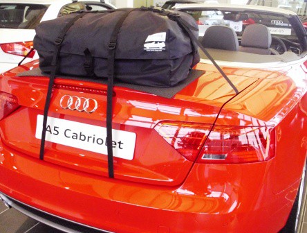 red Audi A4 cabriolet in an audi showroom with a boot-bag original luggage rack fitted