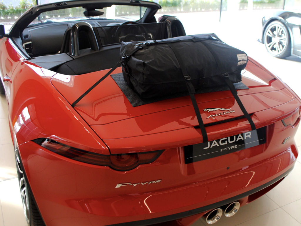 red jaguar f type convertible with a boot-bag original luggage rack fitted