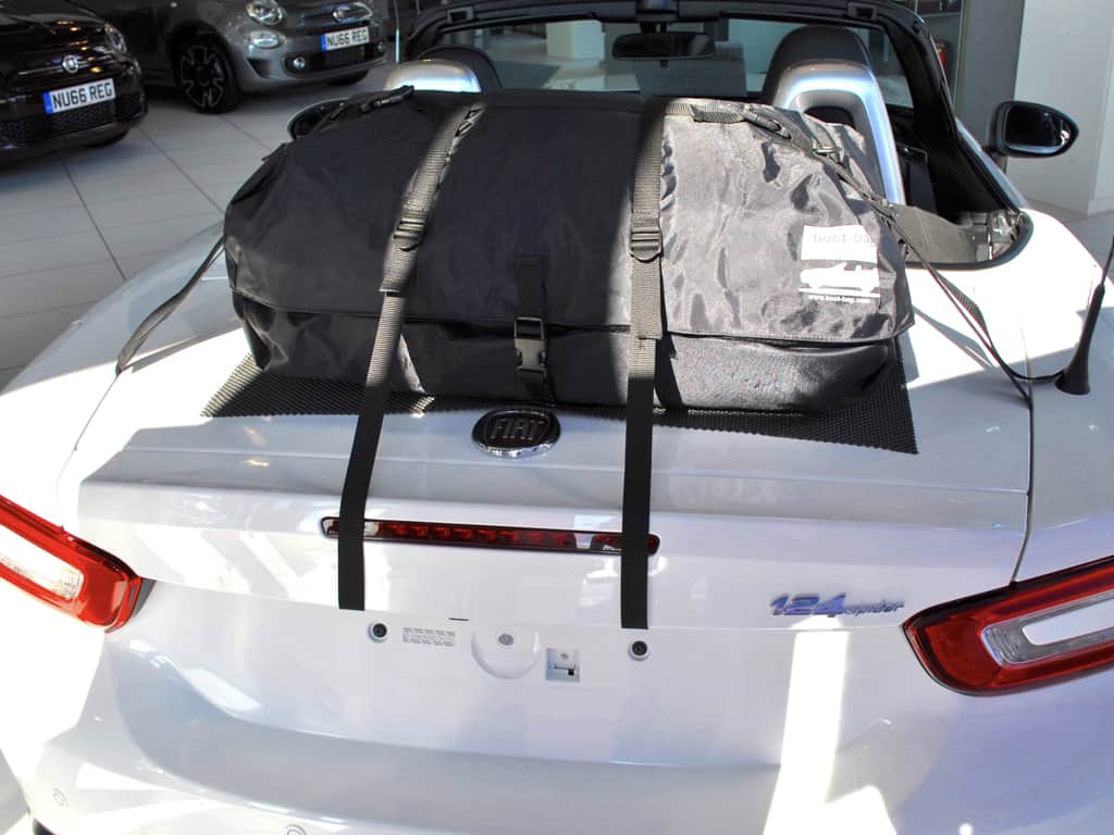 boot-bag original luggage rack fitted to a fiat 124 spider in a fiat showroom