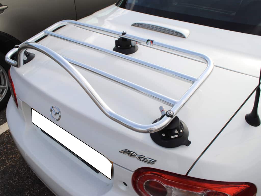 close up of a stainless steel luggage rack fitted to a white mazda mx5 mk3 raodster coupe