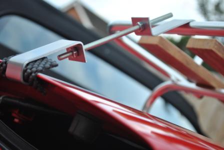 close up of a clamp on a mazda mx5 luggage rack