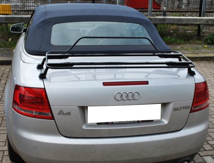 silver audi a4 convertible with a blue hood and a black luggage rack fitted