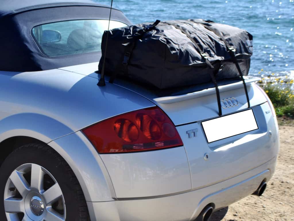 side view of an audi tt MK1 Roadster next to the sea with a boot-bag vacation luggage rack fitted