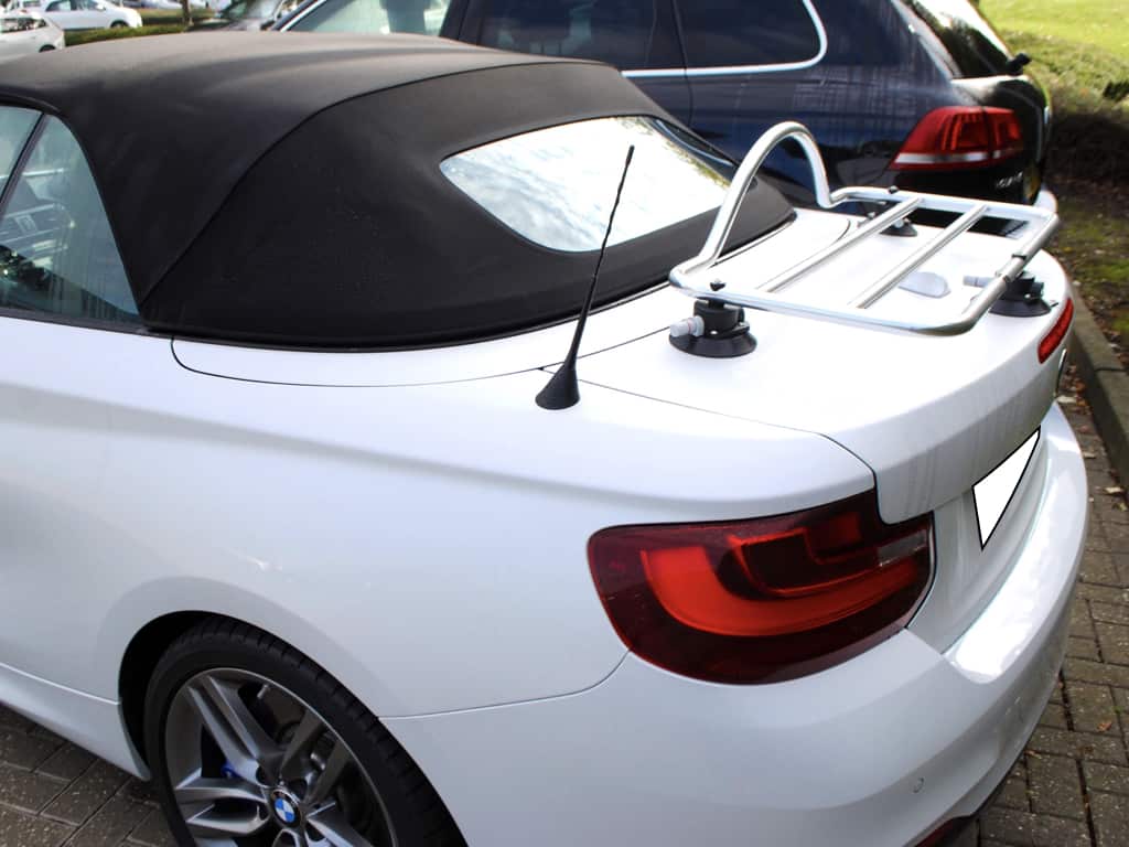 side view of a white bmw 2 series convertible with a revo-rack pa luggage rack fitted