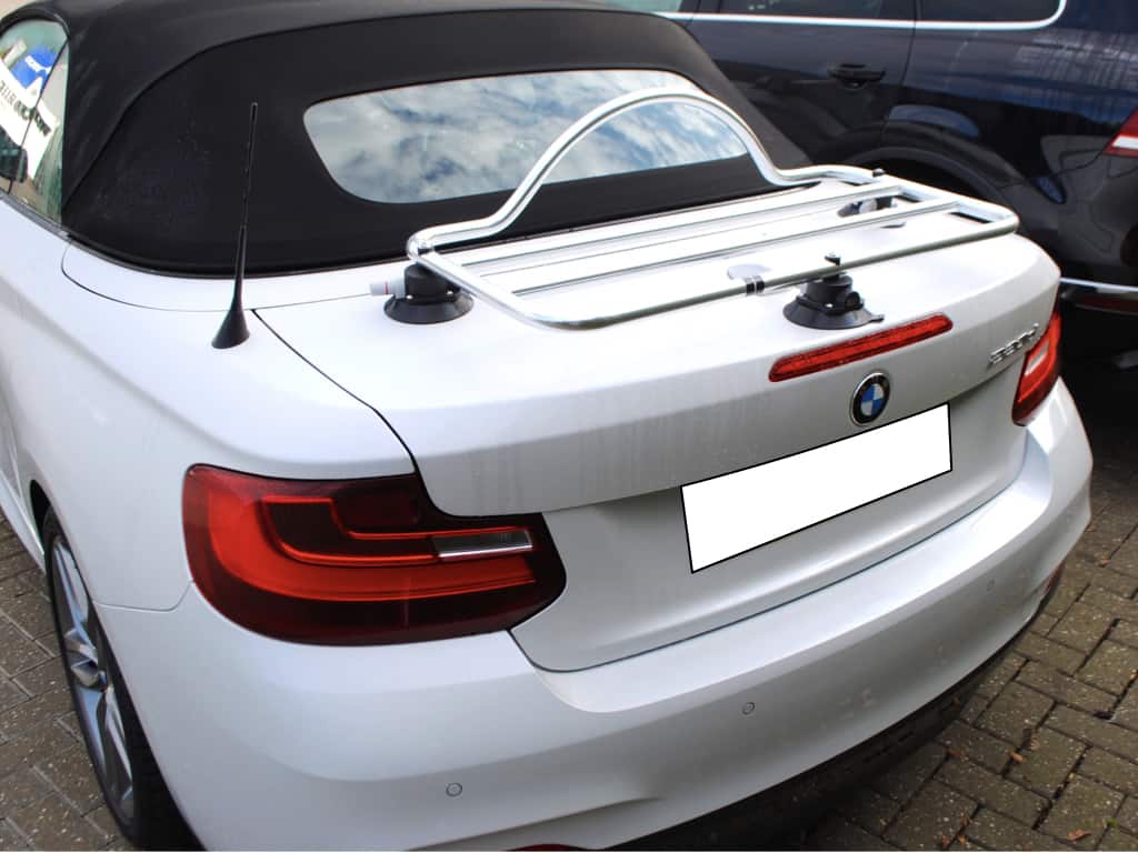 white bmw 2 series convertible with a black hood and a revo-rack pa luggage rack fitted to the boot