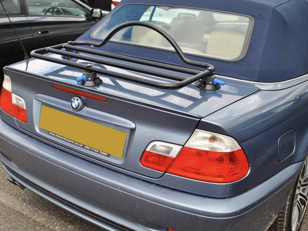light blue e46 bmw 3 series convertible with a black luggage rack fitted to the boot