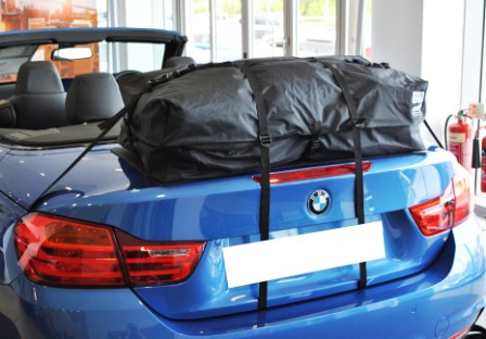 blue bmw 4 series convertible with a boot-bag vacation luggage rack fitted