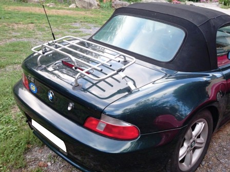 green bmw z3 with the hood up and a chrome luggage rack fitted