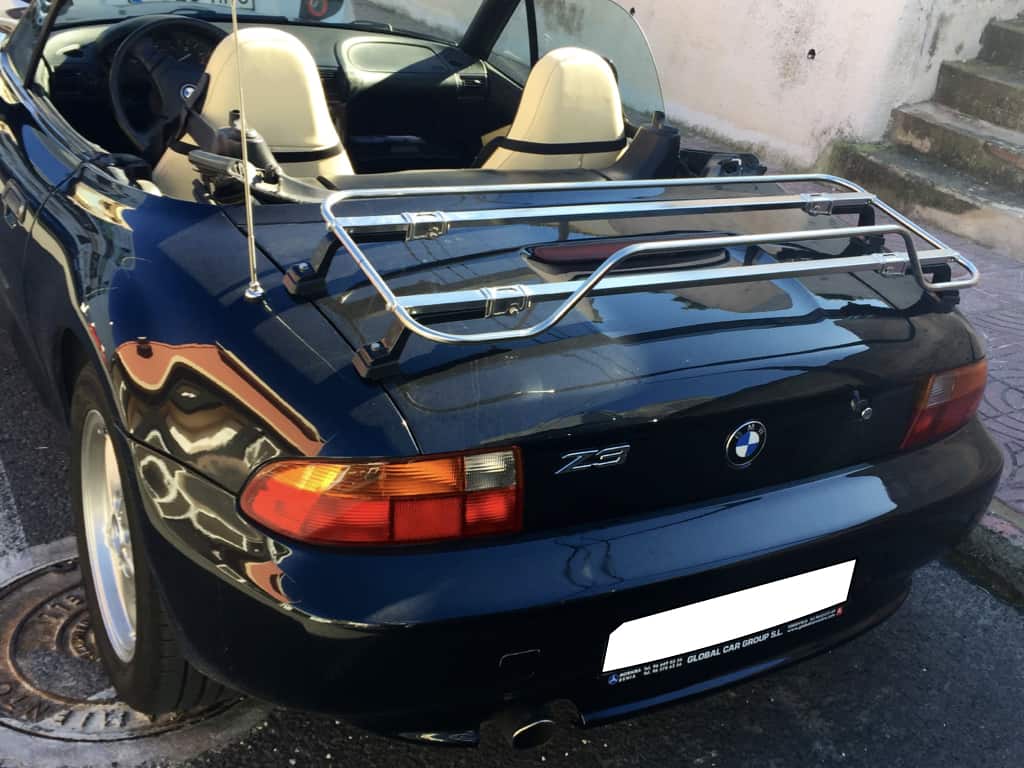 black BMW Z3 with the hood down and a stainless steel luggage rack fitted to the boot