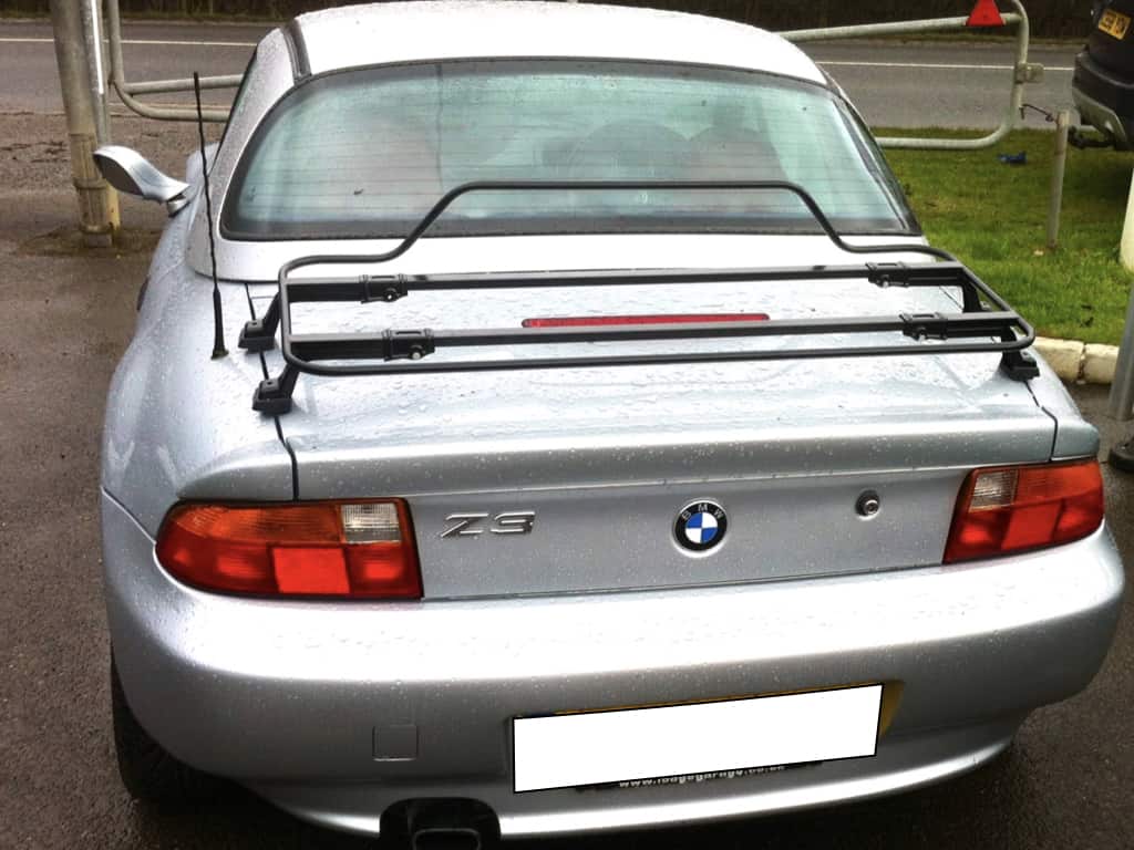 silver bmw z3 with a hard top fitted and a black luggage rack on the boot in the rain