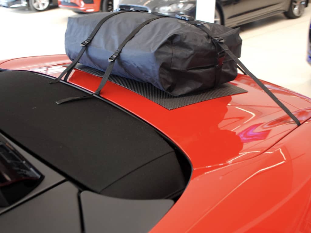 close up of a boot-bag vacation luggage rack fitted to a red jaguar f type
