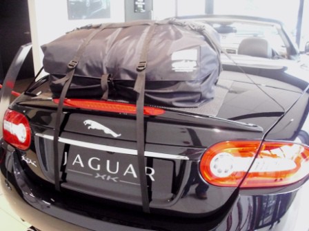 Black Jaguar XK convertible with a boot-bag original luggage rack fitted photographed from behind