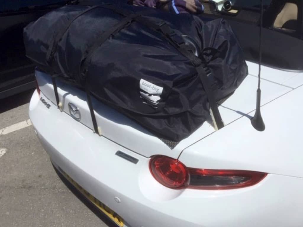 white mazda mx5 mk4 with a boot-bag vacation luggage rack fitted