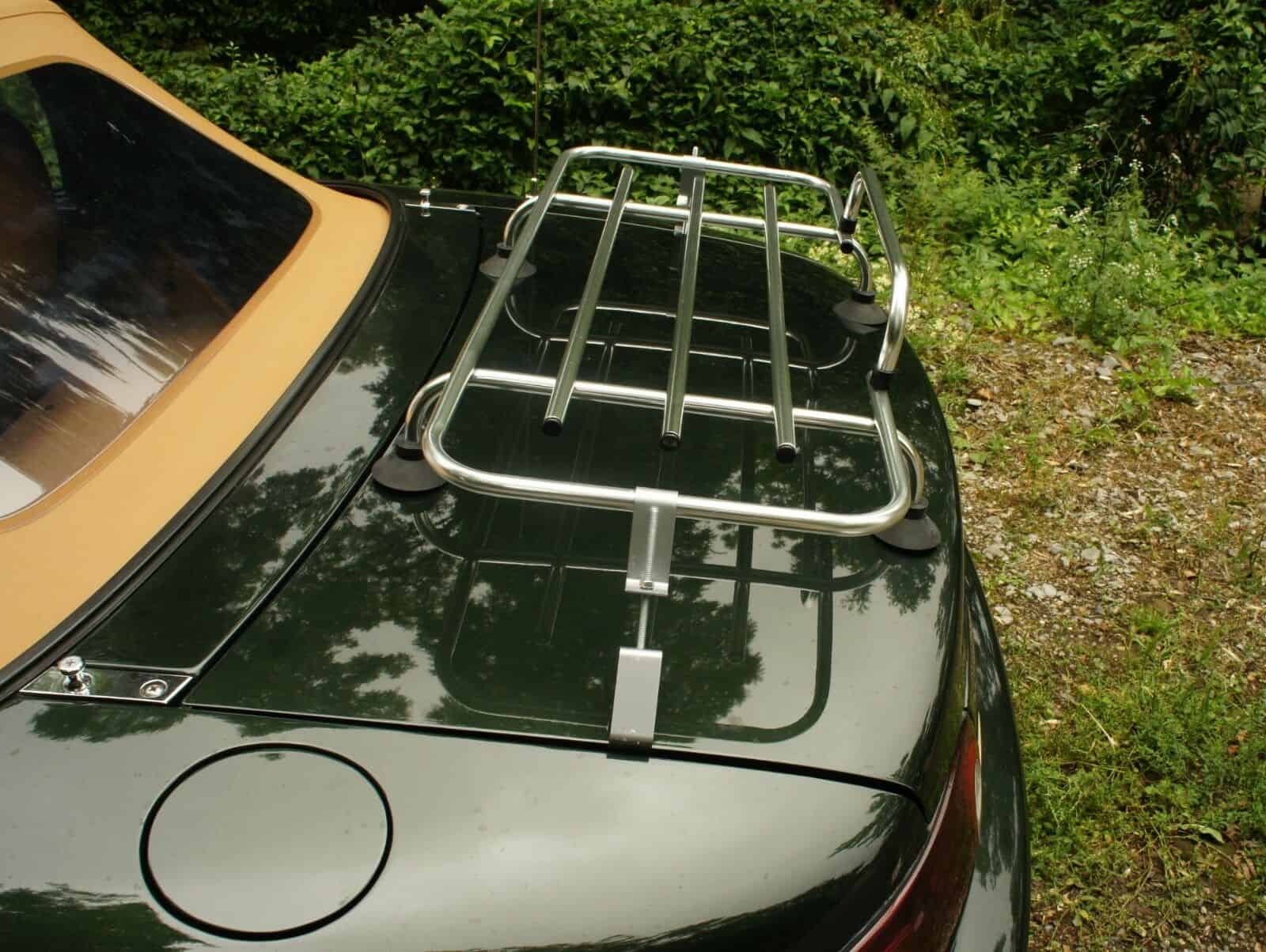 side view of a green mazda mx5 mk1 with a classic chrome luggage rack fitted in 1960's style