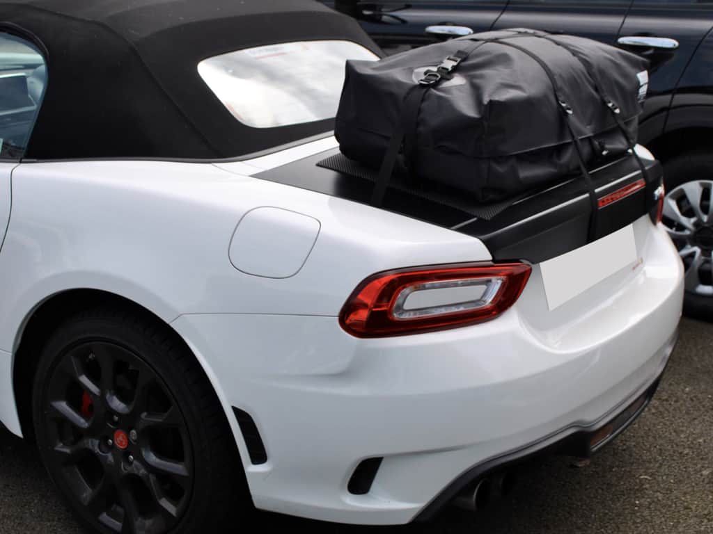 white fiat 124 spider abarth with a boot-bag vacation luggage rack fitted