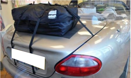 silver jaguar xk8 convertible with the hood down and a boot-bag original luggage rack fitted