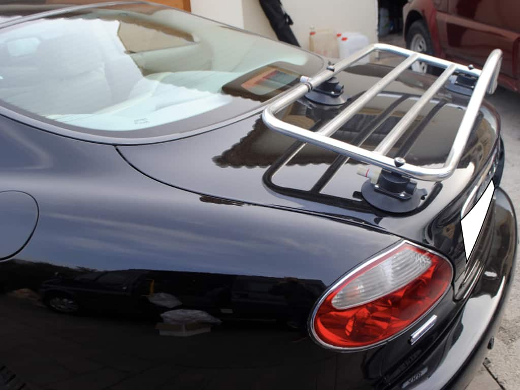 side view of a black jaguar xk8 coupe with a revo-rack pa luggage rack fitted