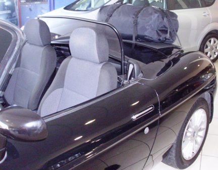 rear view of a boot-bag original luggage rack fitted to a black fiat barchetta