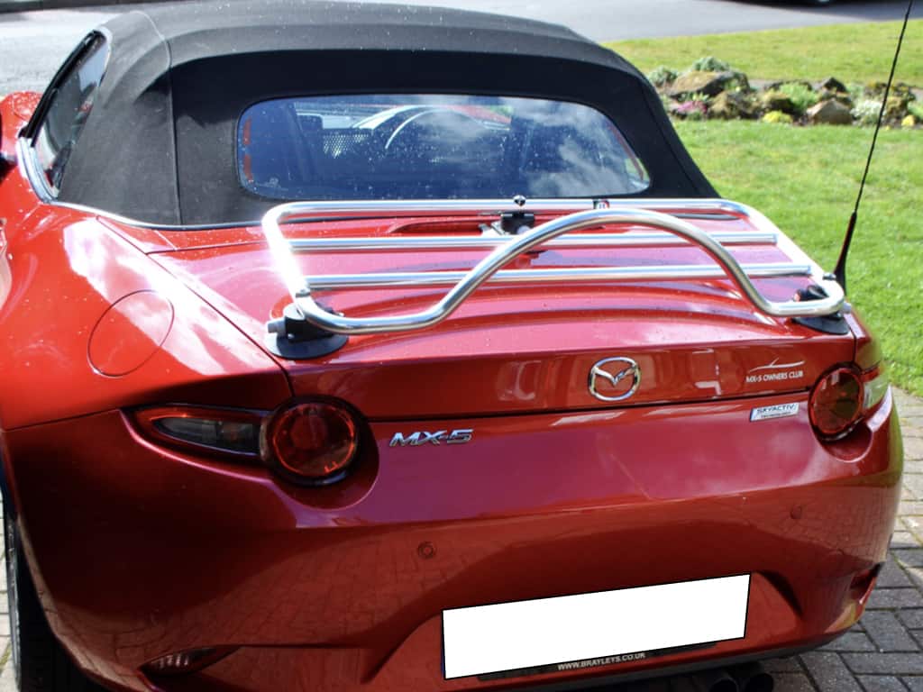 red mx5 mk4 with a chrome luggage rack fitted photographed from behind