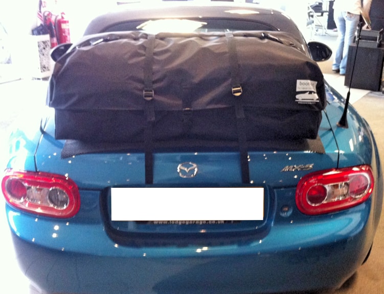 blue mazda mx5 mk3 with a boot-bag vacation luggage rack fitted