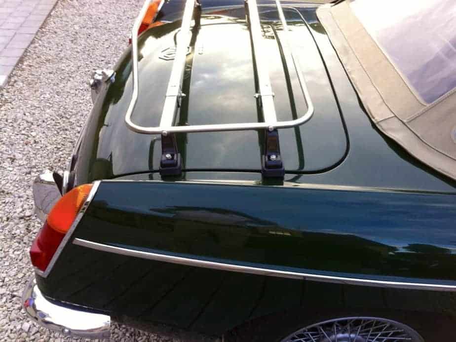 Side view of a stainless steel luggage rack fitted to a green mgb