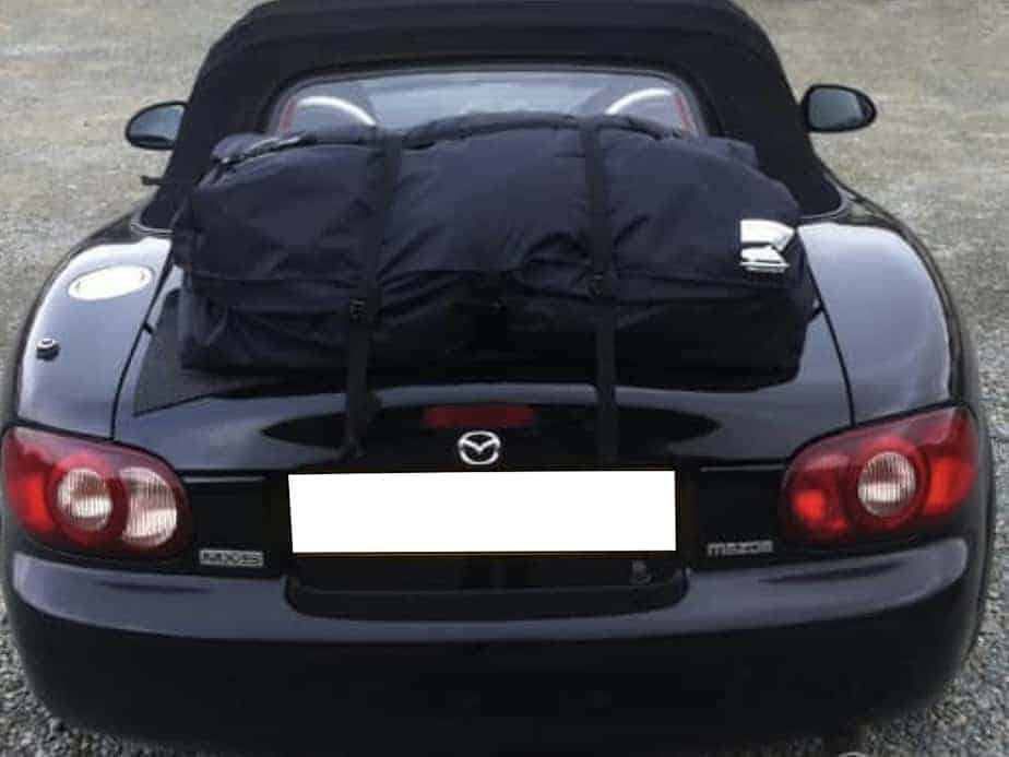 black mazda mx5 mk2 with a boot-bag vacation luggage bag rack fitted