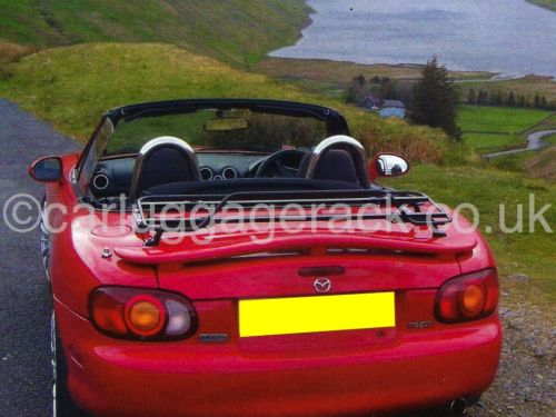 red mazda mx5 mk2 with a rear spoiler and a luggage rack fitted