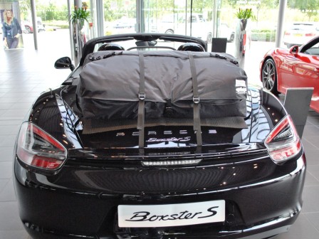 black porsche boxster 981 with a boot-bag vacation luggage bag fitted