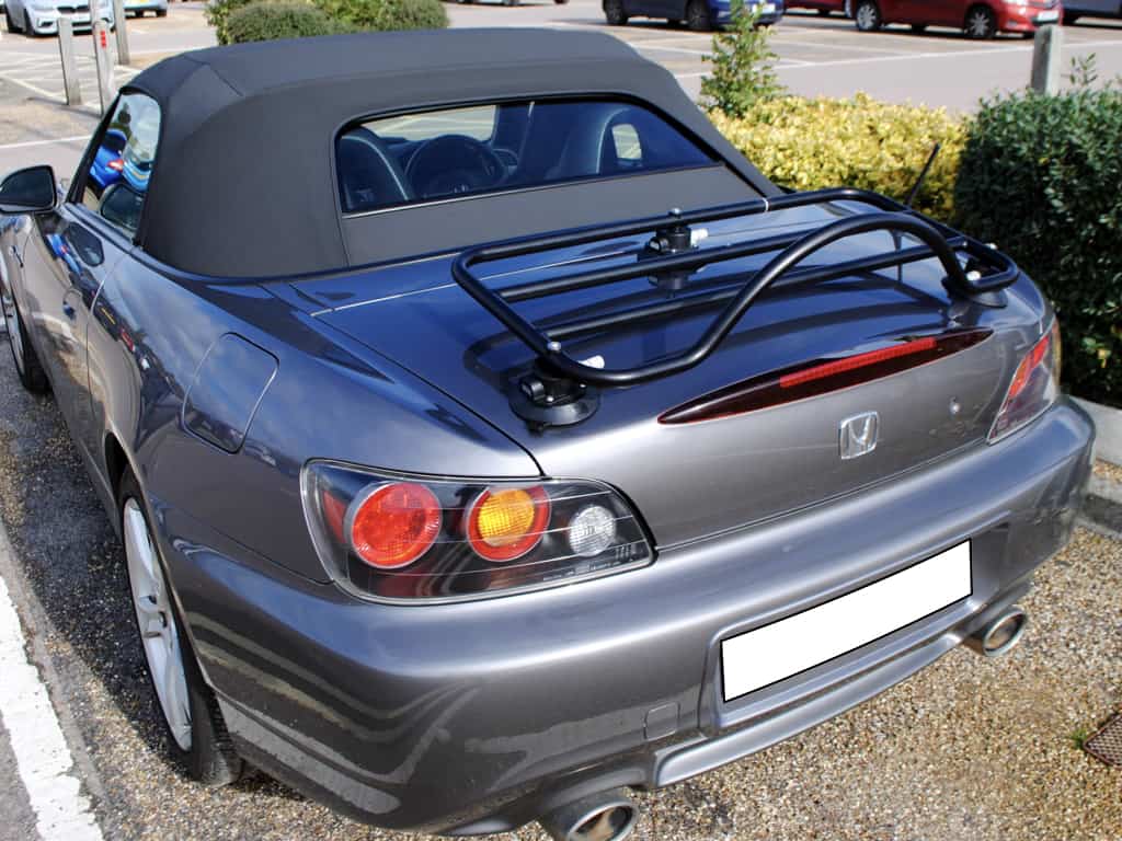 rear view of a graphite honda s2000 with the hood up and a revo-rack luggage rack fitted to the boot