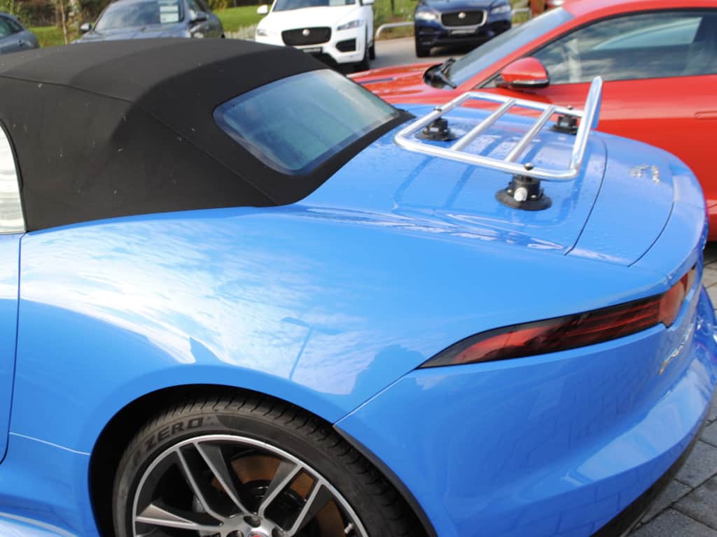 side view of a bright blue jaguar f type convertible with a revo-rack pa luggage rack fitted