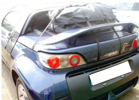 blue smart roadster with rear spoiler and a boot-bag original luggage rack fitted 