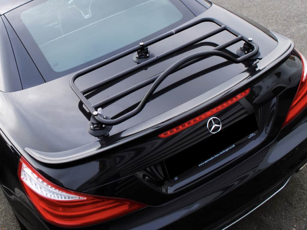 black mercedes benz sl with a black luggage rack fitted photographed from above