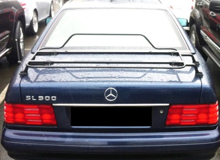 blue mercedes r129 sl with a black luggage rack fitted