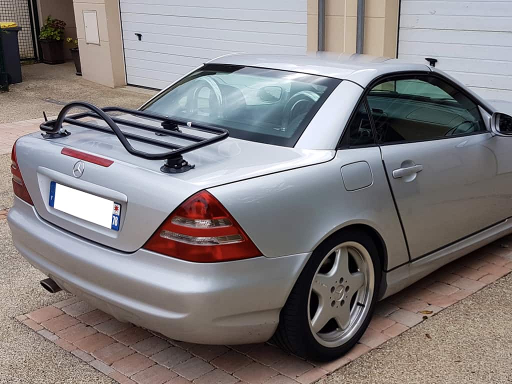 silver mercedes slk r170 230 with a revo-rack black luggage rack fitted on a drive outside a garage