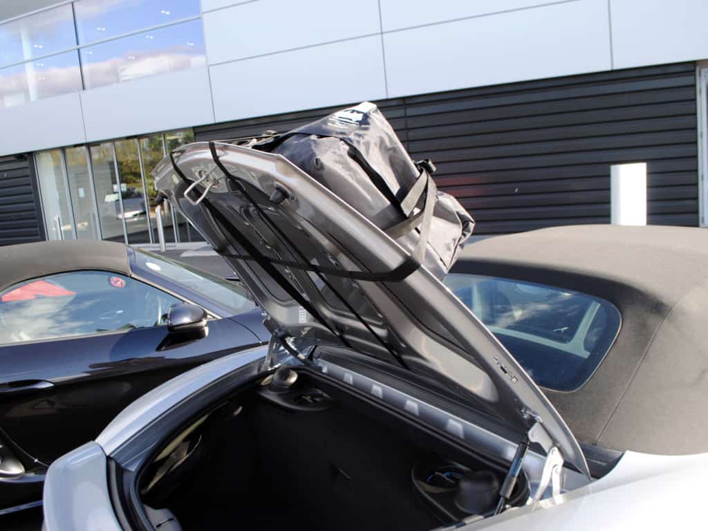 silver porsche boxster 718 962 gts with a boot-bag original fitted to the boot lid, with the boot open showing the straps
