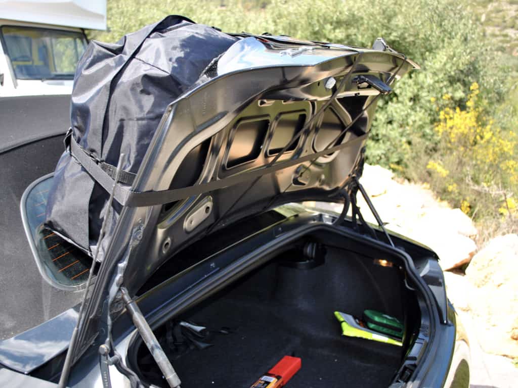 bmw z4 with a boot-bag vacation luggage rack fitted showing the straps under the boot lid.