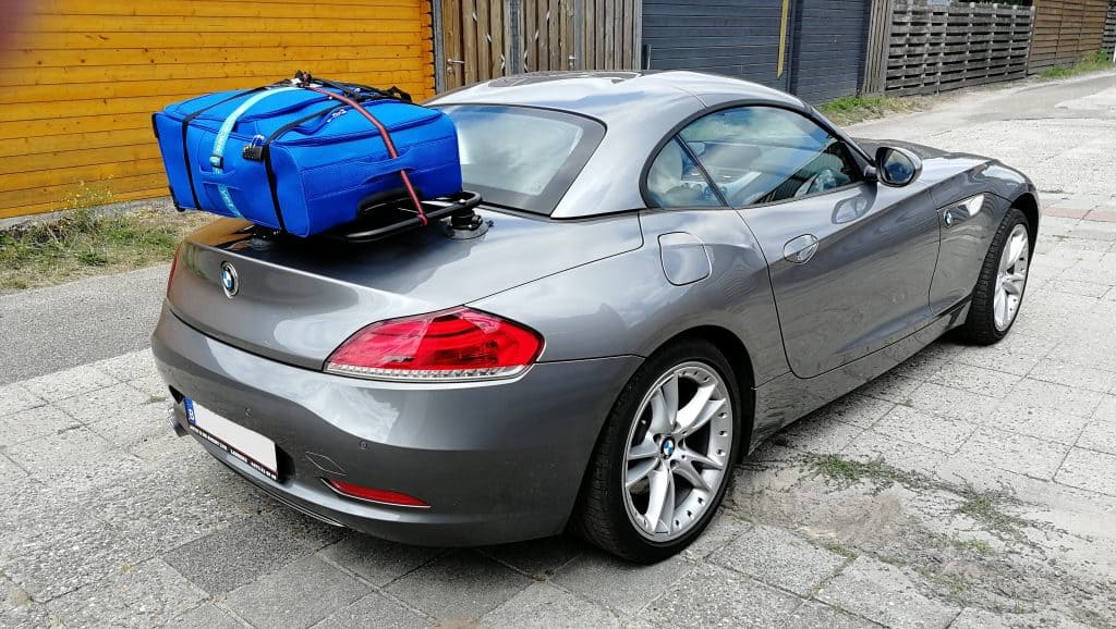 silver bmw z4 e89 with a revo-rack black luggage rack fitted carrying a large blue suitcase