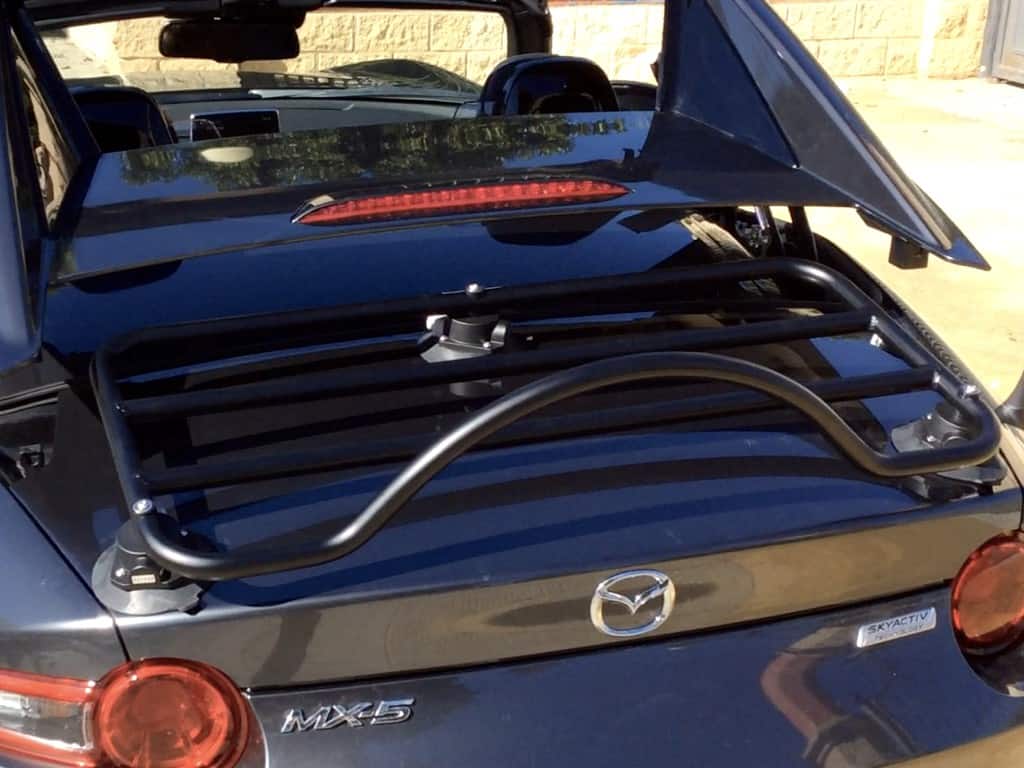 close up of roof operating on mazda mx5 rf with a luggage rack fitted to the boot