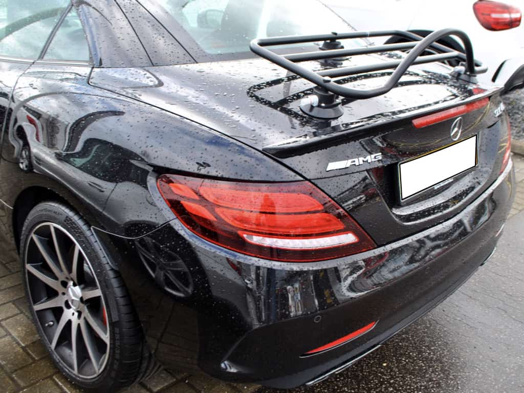 black mercedes benz slc with a black luggage rack fitted photographed close from the side