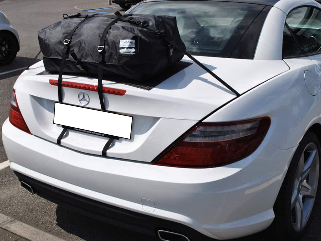 white mercedes benz slk with a boot-bag original luggage rack fitted