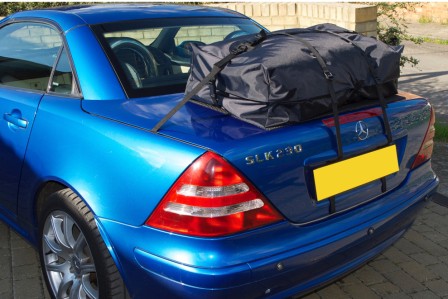 blue mercedes benz slk r170 mk1 with a boot-bag vacation luggage rack fitted on a sunny day
