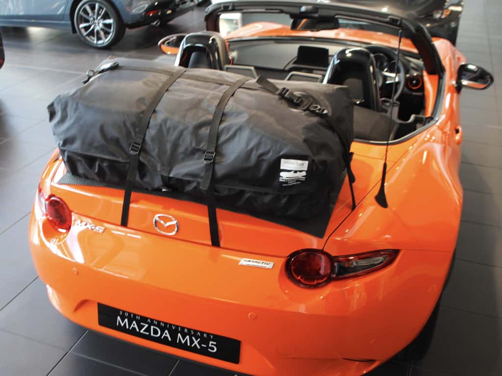 aerial view of a boot-bag vacation fitted to a orange mk4 mx5