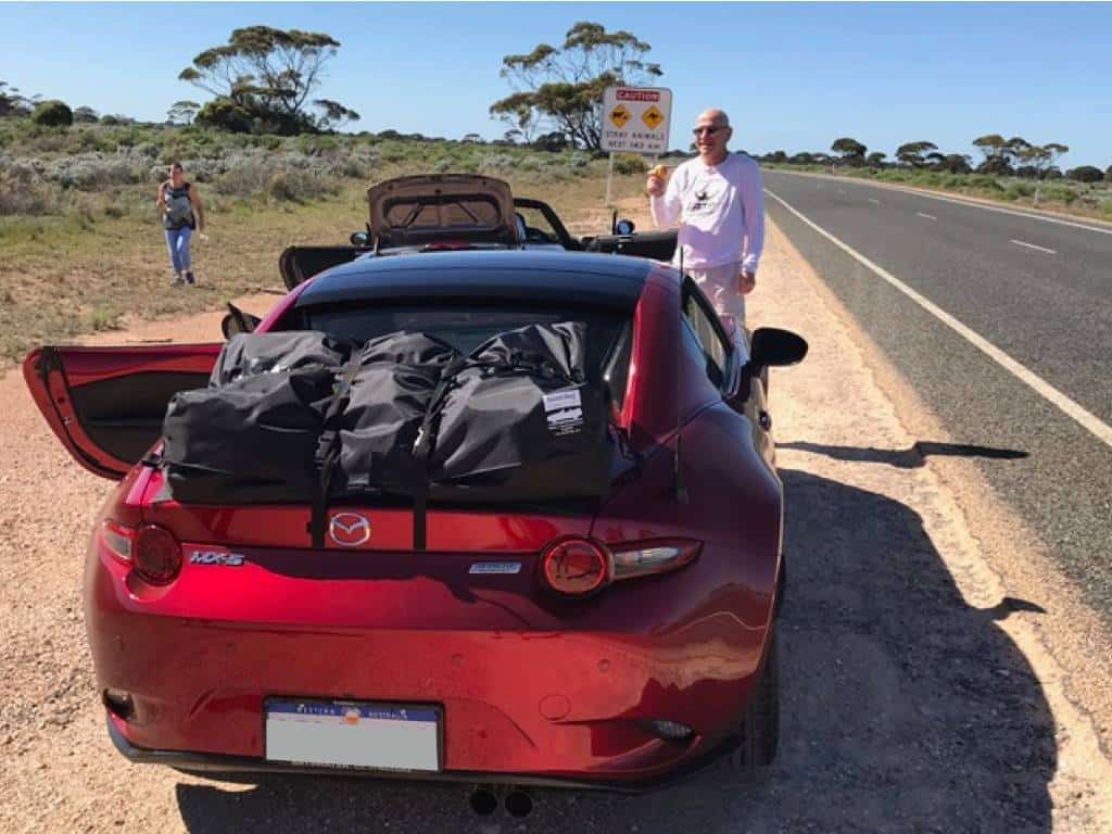 red mazda mx5 rf with a boot-bag vacation fitted in the Australian outback 