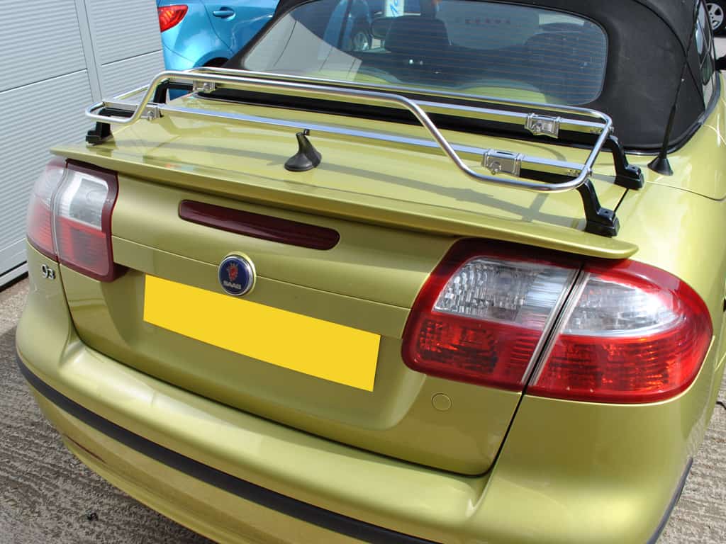 Yellow Saab 93 with black hood parked in garage with Stainless Steel Luggage Rack