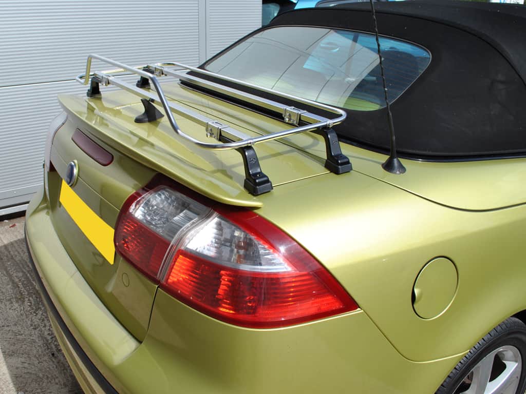 Yellow Saab 93 with black hood parked in garage with Stainless Steel Luggage Rack