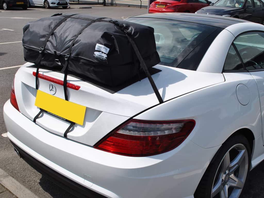 white mercedes slk 200 with a boot-bag vacation luggage rack fitted
