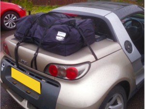 gold smart roadster with a boot-bag vacation luggage bag fitted