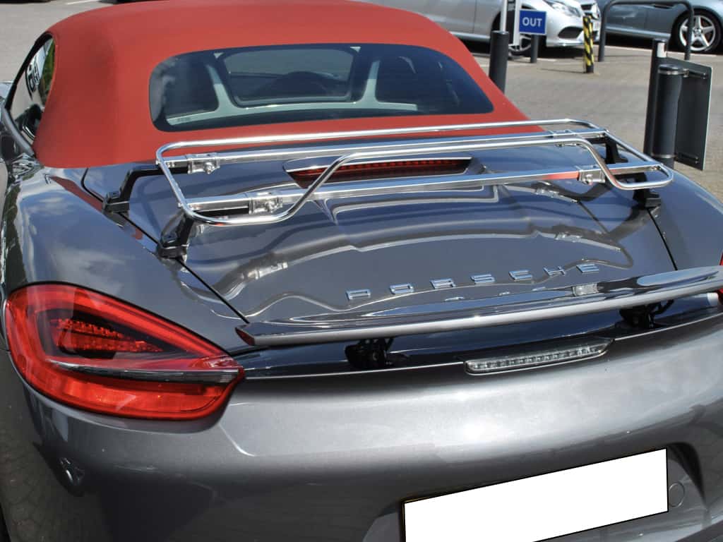 rear view of a dark grey graphite 981 porsche boxster with a luggage rack fitted